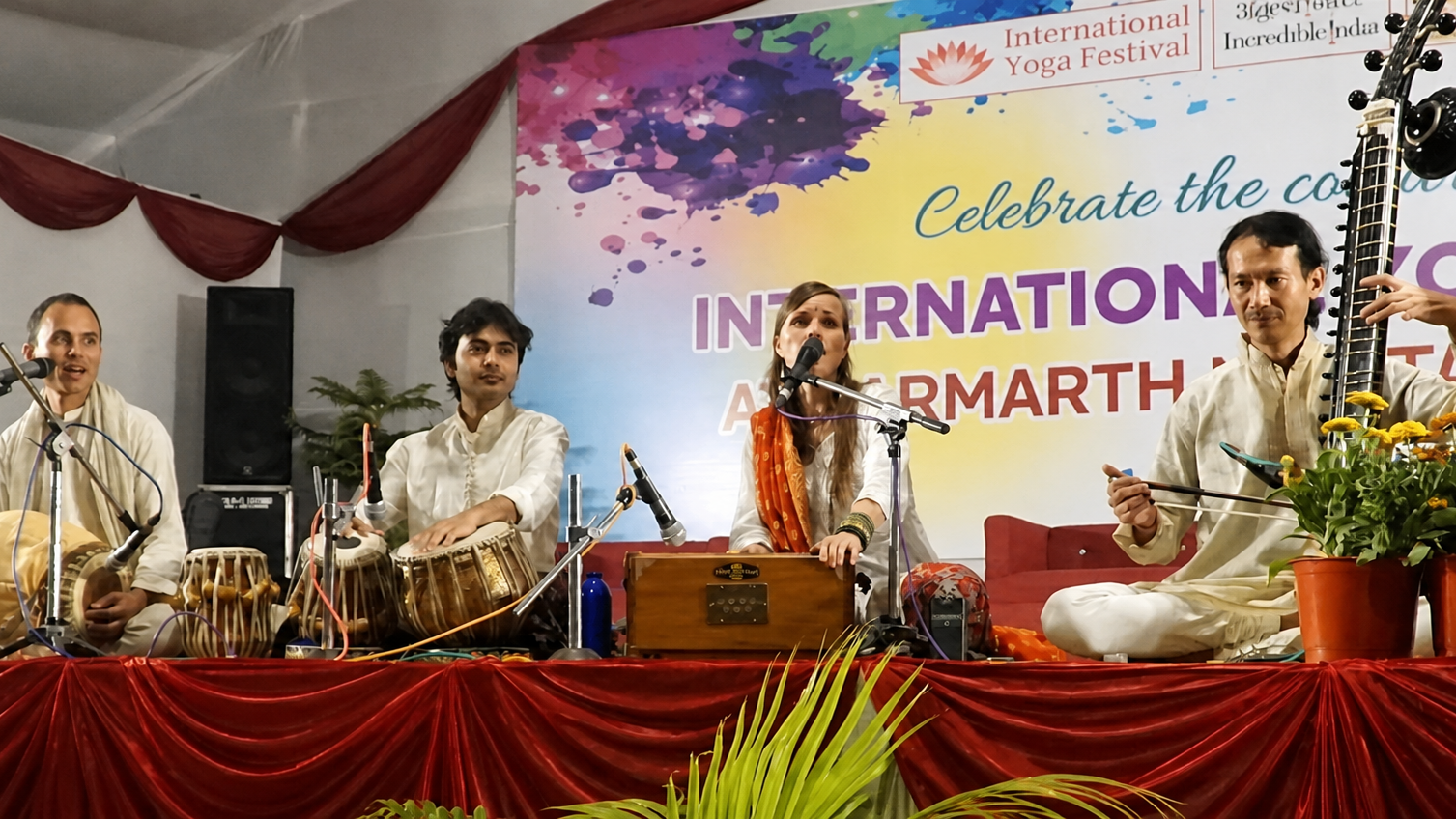 Live kirtan ensemble performing at a yoga festival